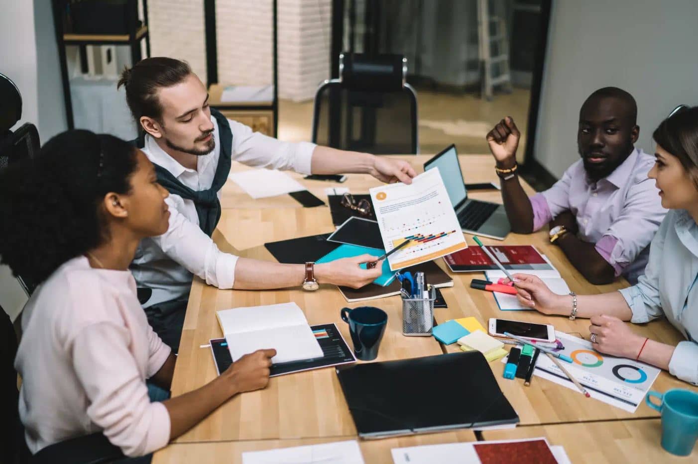 reative-multiethnic-managers-discussing-while-working-together-at-office